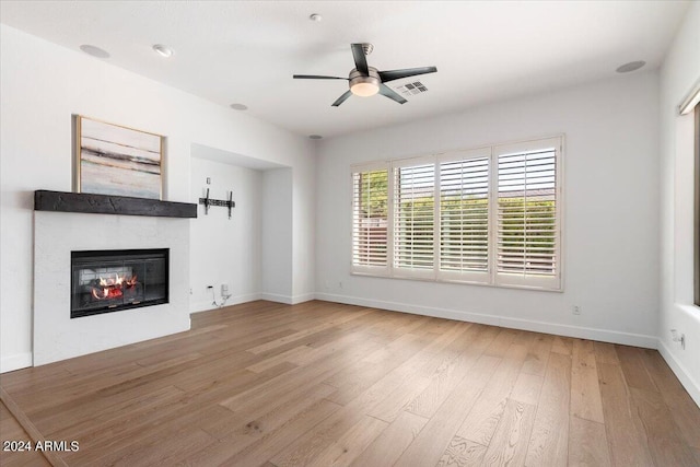 unfurnished living room with ceiling fan and light hardwood / wood-style flooring