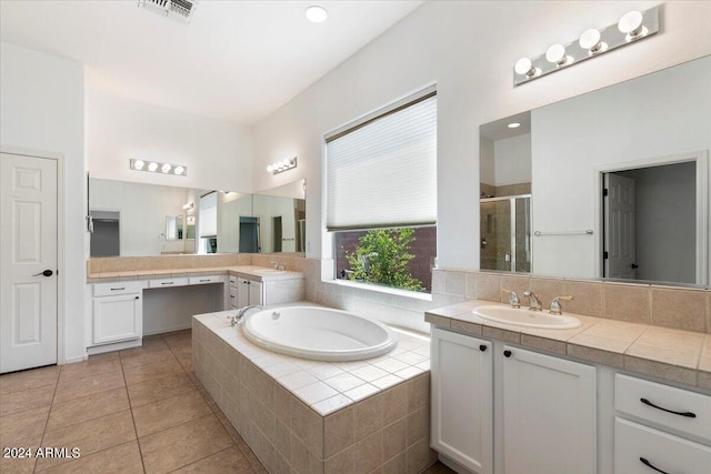 bathroom with tile patterned flooring, vanity, and shower with separate bathtub