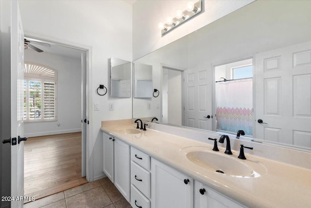 bathroom featuring tile patterned flooring, ceiling fan, a healthy amount of sunlight, and vanity