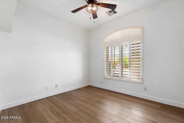 spare room with ceiling fan and wood-type flooring