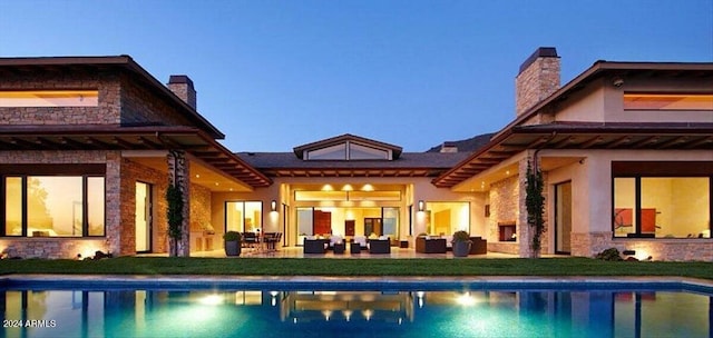 back house at dusk featuring an outdoor hangout area