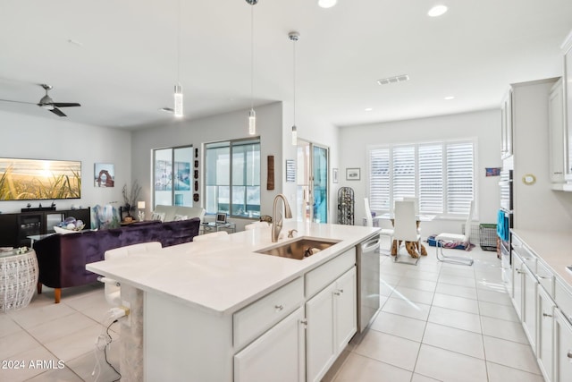 kitchen featuring dishwasher, sink, hanging light fixtures, and plenty of natural light