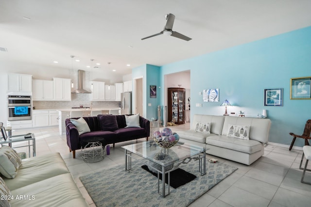 living room featuring ceiling fan and light tile patterned floors