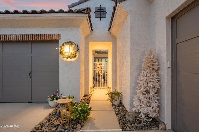 view of exterior entry at dusk