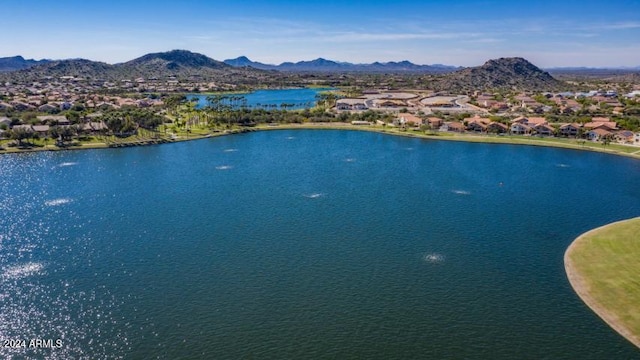 drone / aerial view featuring a water and mountain view