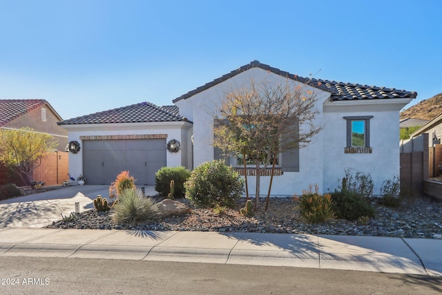 mediterranean / spanish-style house with a garage