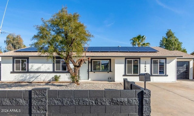 ranch-style home with solar panels