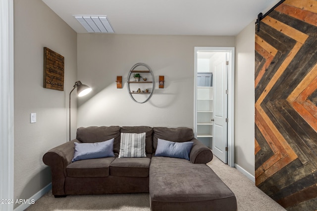 carpeted living room featuring a barn door