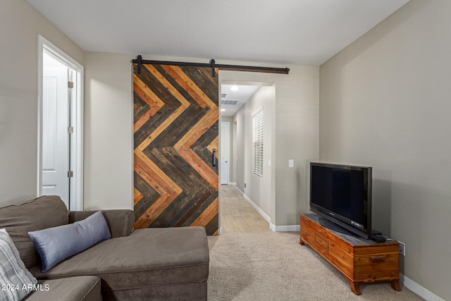 carpeted living room with a barn door