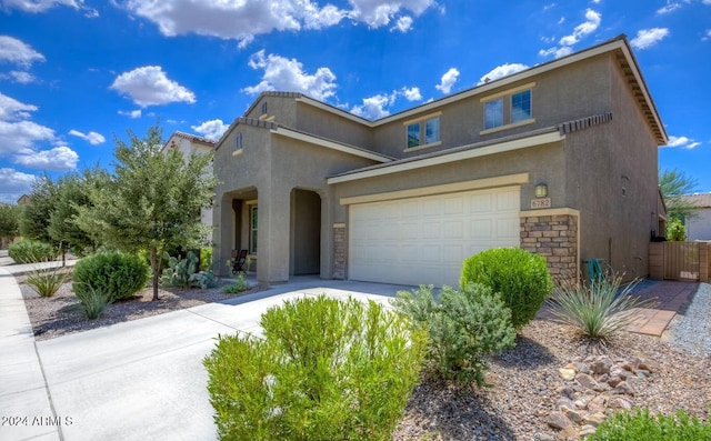 6782 E Via Arroyo Largo, Tucson, AZ 85756 - view of front of home with stucco siding, stone siding, and driveway