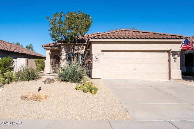 mediterranean / spanish-style home with a garage