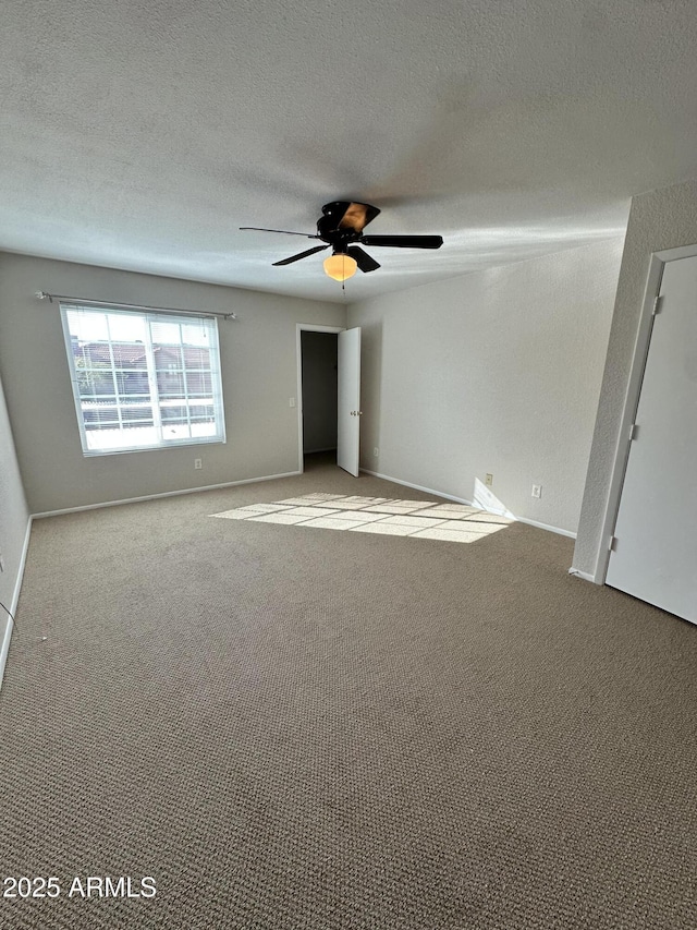 unfurnished bedroom with ceiling fan, light carpet, and a textured ceiling