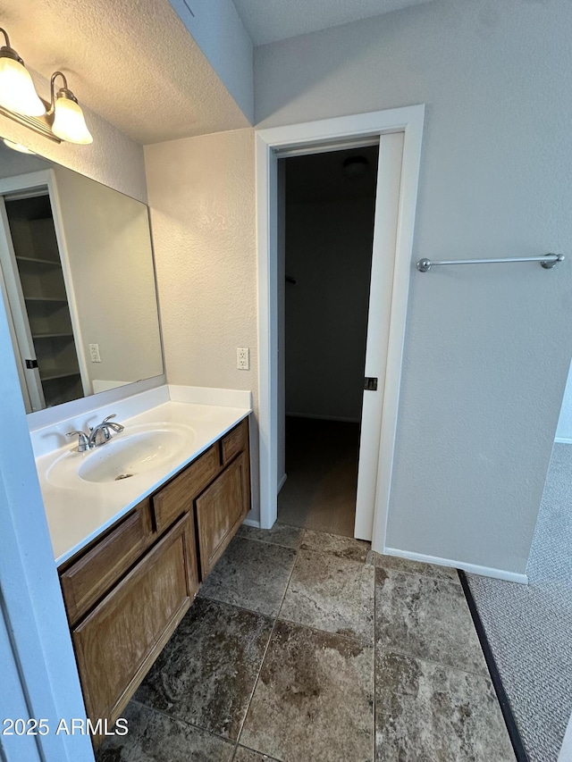 bathroom featuring vanity and a textured ceiling