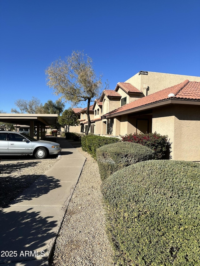 view of side of home featuring a carport