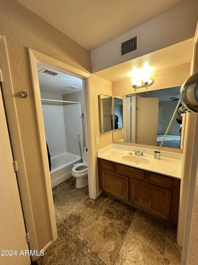 full bathroom with vanity, toilet, and  shower combination