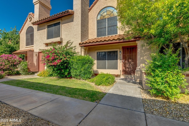 4901 E Kelton Ln Unit 1052, Scottsdale, AZ 85254 - view of front of home with a tile roof and stucco siding