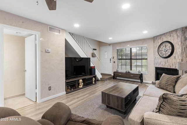 4901 E Kelton Ln Unit 1052, Scottsdale, AZ 85254 - living area with a ceiling fan, stairway, wood finished floors, baseboards, and recessed lighting
