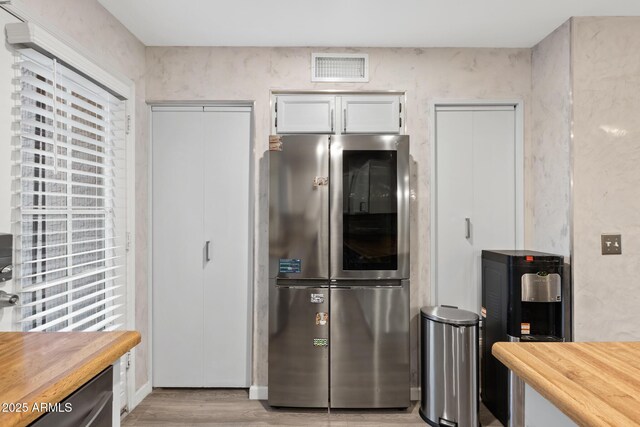 4901 E Kelton Ln Unit 1052, Scottsdale, AZ 85254 - kitchen featuring smart refrigerator, light wood finished floors, butcher block counters, and white cabinetry