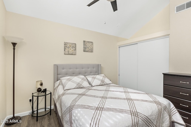 4901 E Kelton Ln Unit 1052, Scottsdale, AZ 85254 - bedroom with dark wood-style floors, a closet, lofted ceiling, a ceiling fan, and baseboards