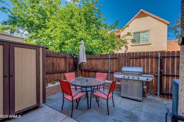 4901 E Kelton Ln Unit 1052, Scottsdale, AZ 85254 - view of patio / terrace featuring a grill, a fenced backyard, and outdoor dining area
