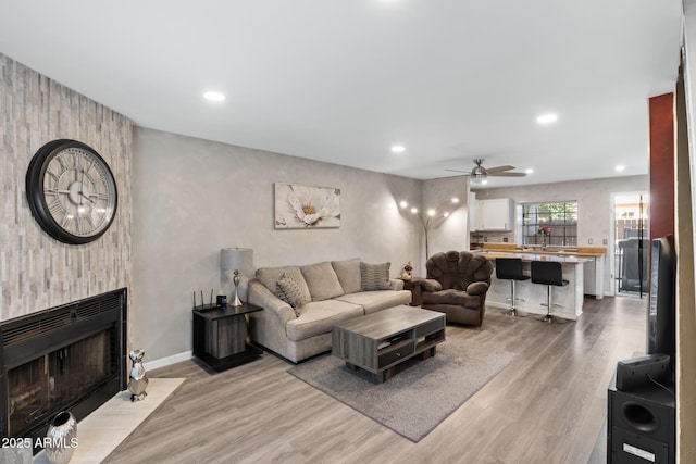 4901 E Kelton Ln Unit 1052, Scottsdale, AZ 85254 - living room with a ceiling fan, light wood-style flooring, recessed lighting, baseboards, and a fireplace
