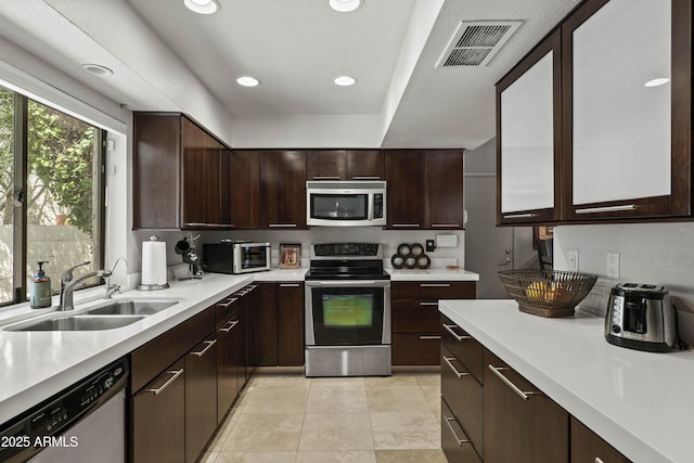 7714 N 17th Pl, Phoenix, AZ 85020 - kitchen featuring light countertops, stainless steel appliances, visible vents, and a sink