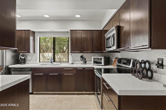 7714 N 17th Pl, Phoenix, AZ 85020 - kitchen with dark brown cabinetry, appliances with stainless steel finishes, a sink, a toaster, and light countertops