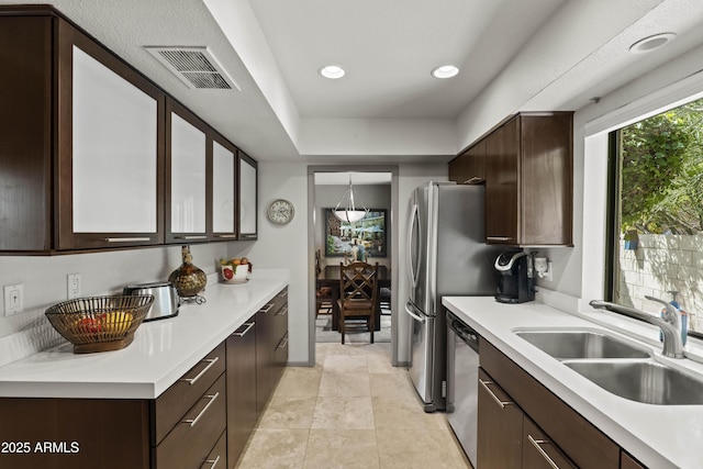 7714 N 17th Pl, Phoenix, AZ 85020 - kitchen featuring a sink, dishwasher, dark brown cabinetry, and visible vents