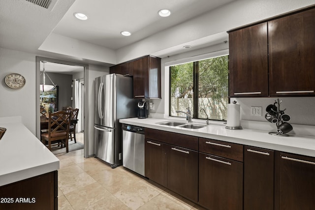 7714 N 17th Pl, Phoenix, AZ 85020 - kitchen with a sink, appliances with stainless steel finishes, dark brown cabinets, and light countertops