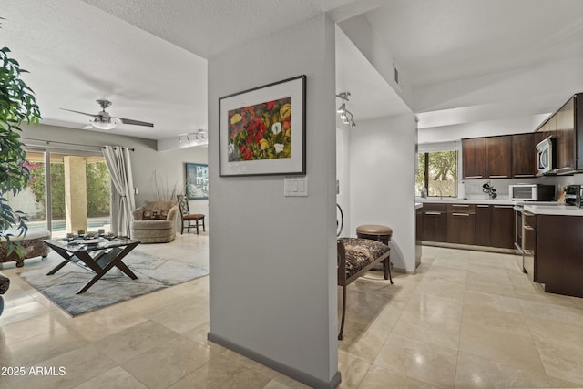 7714 N 17th Pl, Phoenix, AZ 85020 - living area with a ceiling fan, a textured ceiling, and light tile patterned floors