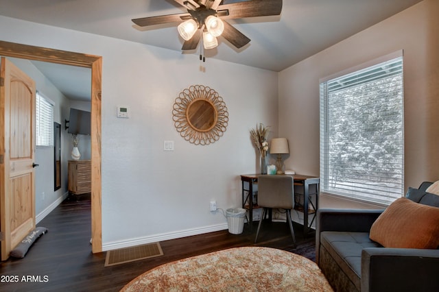 sitting room featuring dark hardwood / wood-style flooring and ceiling fan