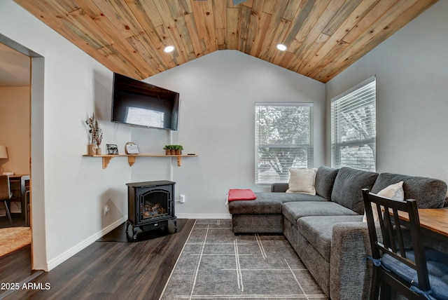 living room featuring dark hardwood / wood-style floors, vaulted ceiling, a wood stove, and wood ceiling