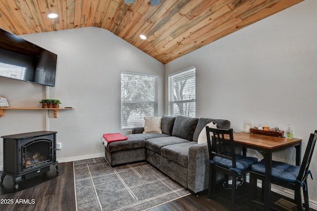 living room with vaulted ceiling, a wood stove, wooden ceiling, and dark hardwood / wood-style flooring