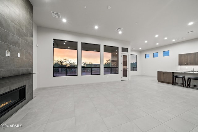 living room featuring a fireplace and tile walls