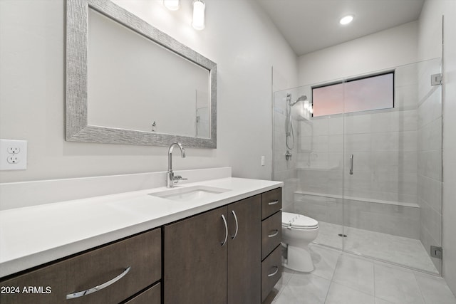 bathroom with vanity, toilet, a shower with shower door, and tile patterned floors