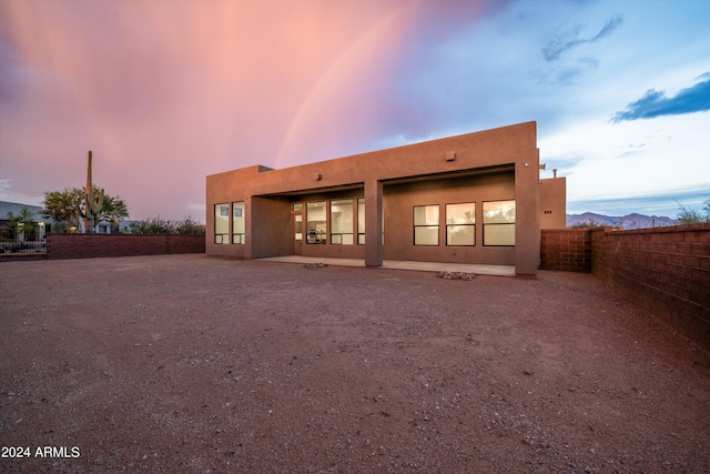 view of back house at dusk