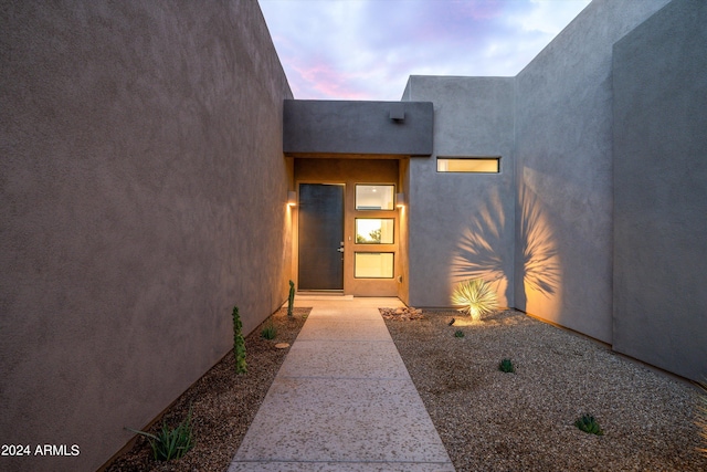 view of exterior entry at dusk