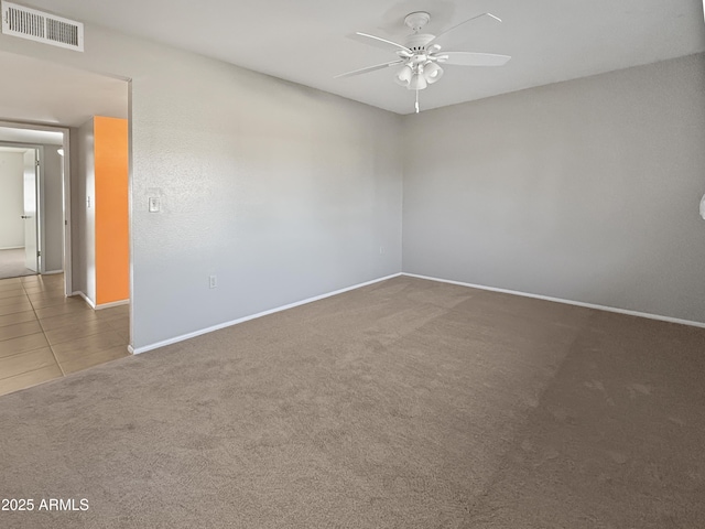 spare room featuring ceiling fan and carpet