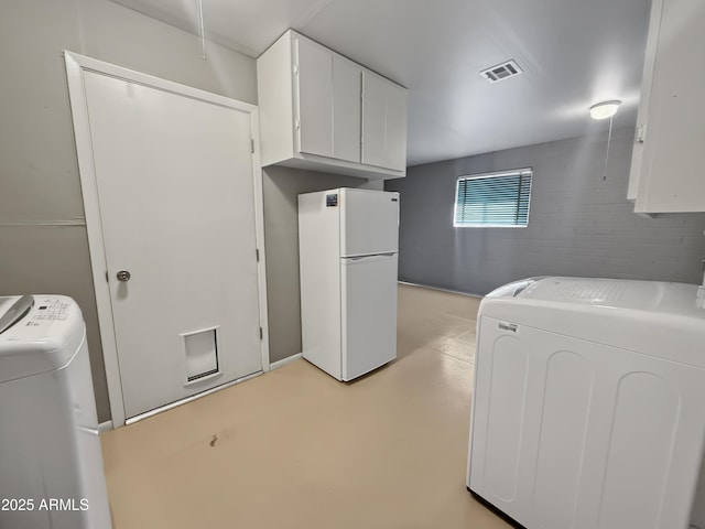 washroom with cabinets and washer and clothes dryer