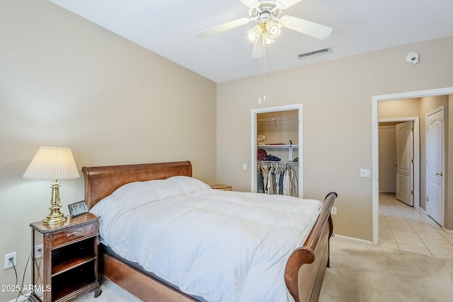 15960 W Indigo Ln, Surprise, AZ 85374 - bedroom with light colored carpet, a closet, a spacious closet, a ceiling fan, and baseboards