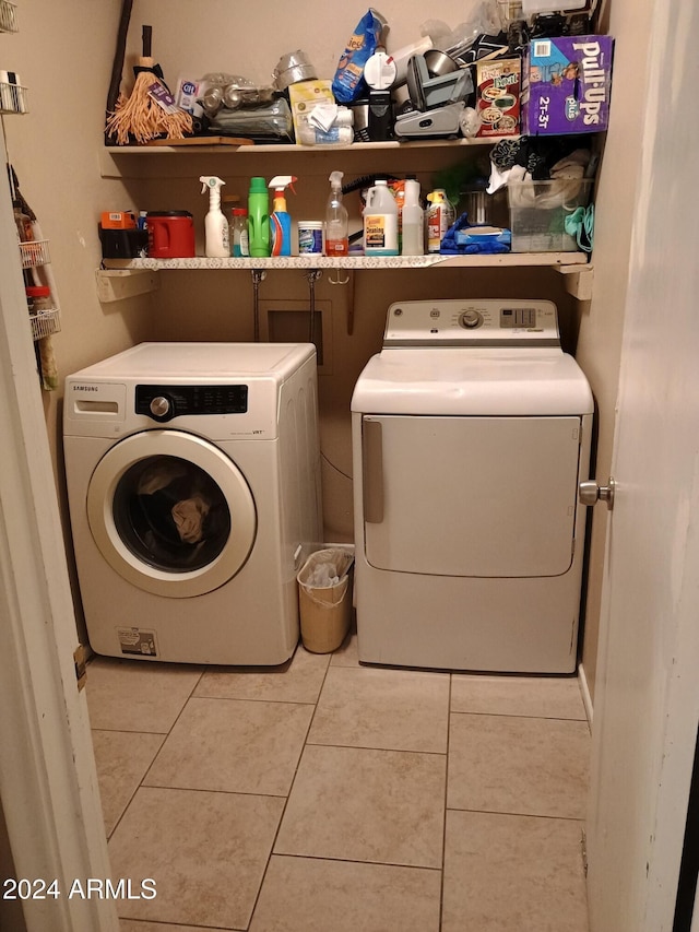 washroom with tile patterned floors and washing machine and clothes dryer