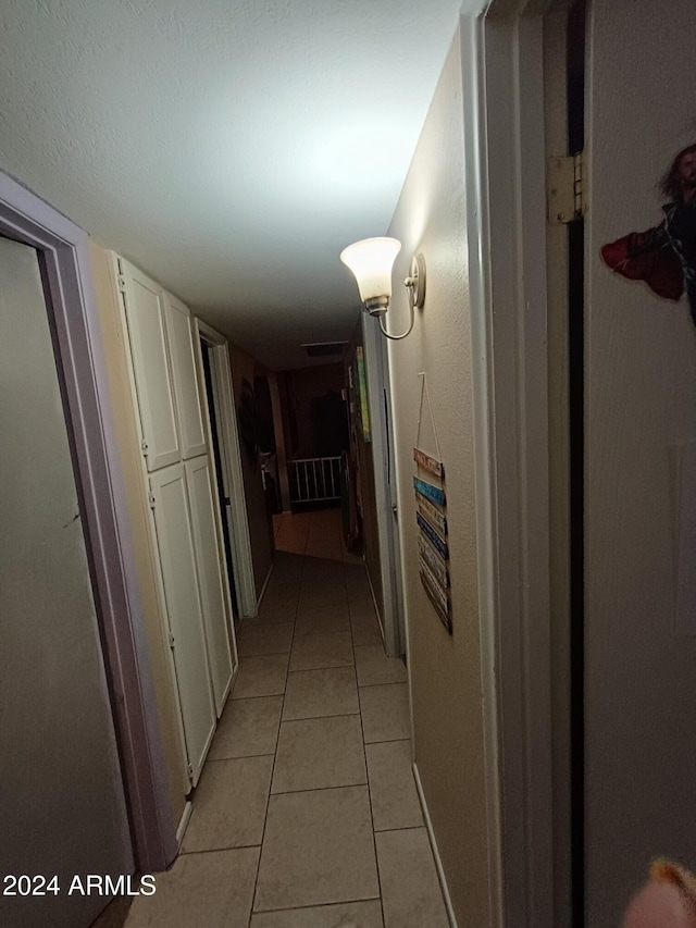 hallway featuring light tile patterned flooring