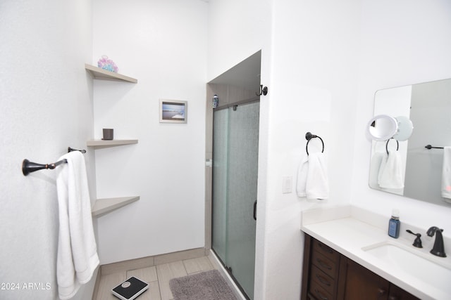 bathroom featuring vanity and a shower with shower door