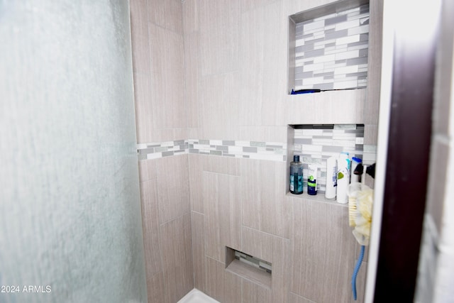 bathroom with a tile shower