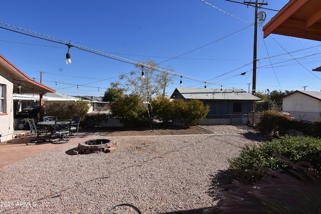 view of yard with a patio and a fire pit