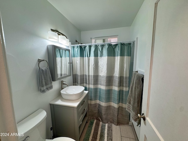 bathroom with vanity, toilet, and walk in shower