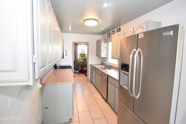 kitchen featuring white cabinets, sink, and appliances with stainless steel finishes