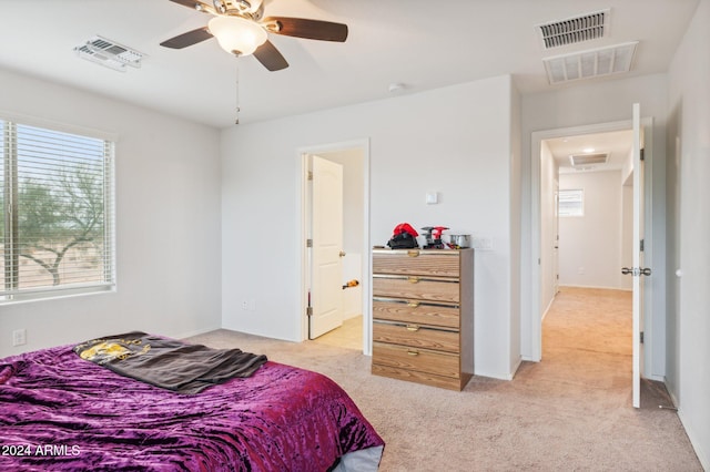 carpeted bedroom with multiple windows and ceiling fan