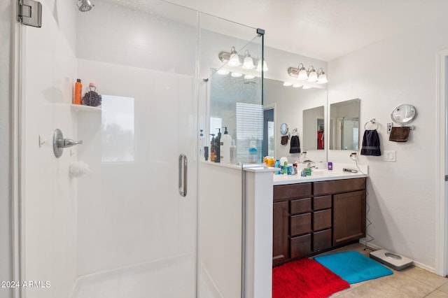 bathroom featuring tile patterned floors, vanity, and a shower with door