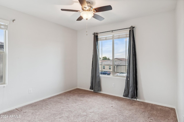 carpeted spare room with ceiling fan